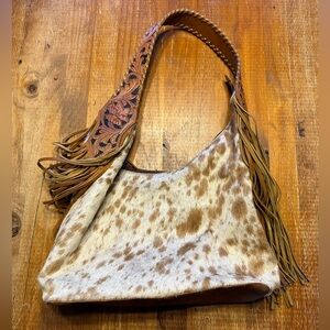 Cowhide shoulder tote that’s conceal carry ready.